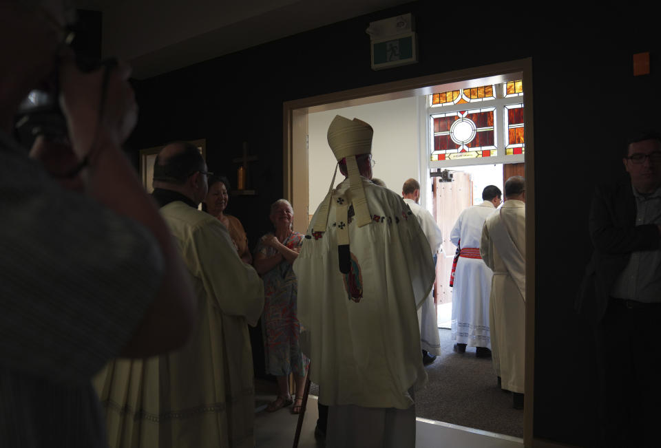 Edmonton Archbishop Richard Smith, center, and his fellow clergymen conclude the rededication ceremony and Sunday Mass at Sacred Heart Church of the First Peoples, July 17, 2022, in Edmonton, Alberta. In 2020, the church was damaged in a large fire and has now been renovated ahead of Pope Francis' visit to the Canadian province. (AP Photo/Jessie Wardarski)