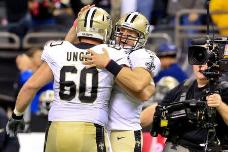 Oct 4, 2015; New Orleans, LA, USA; New Orleans Saints quarterback Drew Brees (9) celebrates with center Max Unger (60) after throwing an 80 yard game winning touchdown pass to running back C.J. Spiller (not pictured) during overtime against the Dallas Cowboys at the Mercedes-Benz Superdome. Derick E. Hingle-USA TODAY Sports