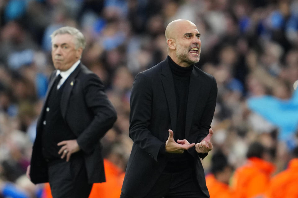 Manchester City's head coach Pep Guardiola reacts after Bernardo Silva scored the opening goal during the Champions League semifinal second leg soccer match between Manchester City and Real Madrid at Etihad stadium in Manchester, England, Wednesday, May 17, 2023. (AP Photo/Jon Super)