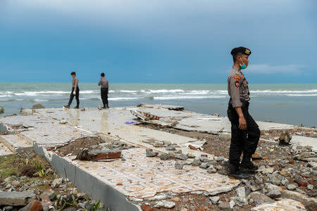 Police officers search for victims among rubble of a destroyed beach front hotel which was hit by a tsunami in Pandeglang, Banten province, Indonesia, December 24, 2018. REUTERS/Jorge Silva