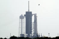 The SpaceX Falcon 9, with the Crew Dragon spacecraft on top of the rocket, sits on Launch Pad 39-A Thursday, May 28, 2020, at Kennedy Space Center in Cape Canaveral, Fla. Wednesday's planned launch was scrubbed due to weather. They will try again to launch Saturday. (AP Photo/David J. Phillip)