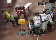 Winner Usain Bolt of Jamaica (L) sits on a chair next to second placed Justin Gatlin of the U.S. (2nd L) after competing at the men's 200 metres final during the 15th IAAF World Championships at the National Stadium in Beijing, China, August 27, 2015. REUTERS/Kim Kyung-Hoon TPX IMAGES OF THE DAY