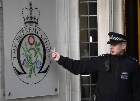 A police officer stands on duty outside outside the Supreme Court ahead of the challenge against a court ruling that Theresa May's government requires parliamentary approval to start the process of leaving the European Union, in Parliament Square, central London, Britain December 5, 2016. REUTERS/Toby Melville