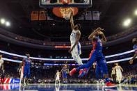 Nov 3, 2018; Philadelphia, PA, USA; Philadelphia 76ers center Joel Embiid (21) dunks past Detroit Pistons guard Ish Smith (14) during the second quarter at Wells Fargo Center. Bill Streicher-USA TODAY Sports