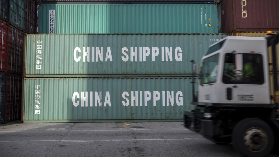 FILE- In this July, 5, 2018, file photo, a jockey truck passes a stack of 40-foot China Shipping containers at the Port of Savannah in Savannah, Ga. The path to peace in a trade war between the United States and China is getting harder to find as the world's two biggest economies pile ever more taxes on each other's products. (AP Photo/Stephen B. Morton, File)