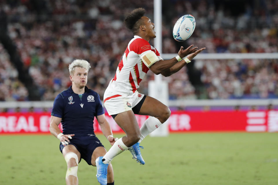 Japan's Kotaro Matsushima jumps to catch a ball during the Rugby World Cup Pool A game at International Stadium between Japan and Scotland in Yokohama, Japan, Sunday, Oct. 13, 2019. (AP Photo/Eugene Hoshiko)