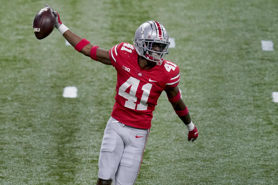 Ohio State safety Josh Proctor celebrates after intercepting a pass during the second half of the Big Ten championship NCAA college football game against Northwestern, Saturday, Dec. 19, 2020, in Indianapolis. (AP Photo/Darron Cummings)