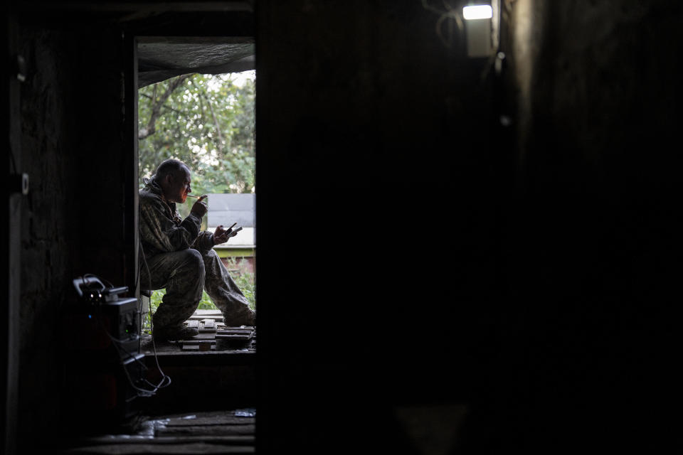 A Ukrainian soldier lights a cigarette in between drone operations on the front line in the Luhansk region, Ukraine, Saturday, Aug. 19, 2023. Moscow’s army is staging a ferocious push in northeast Ukraine designed to distract Ukrainian forces from their counteroffensive and minimize the number of troops Kyiv is able to send to more important battles in the south.(AP Photo/Bram Janssen)