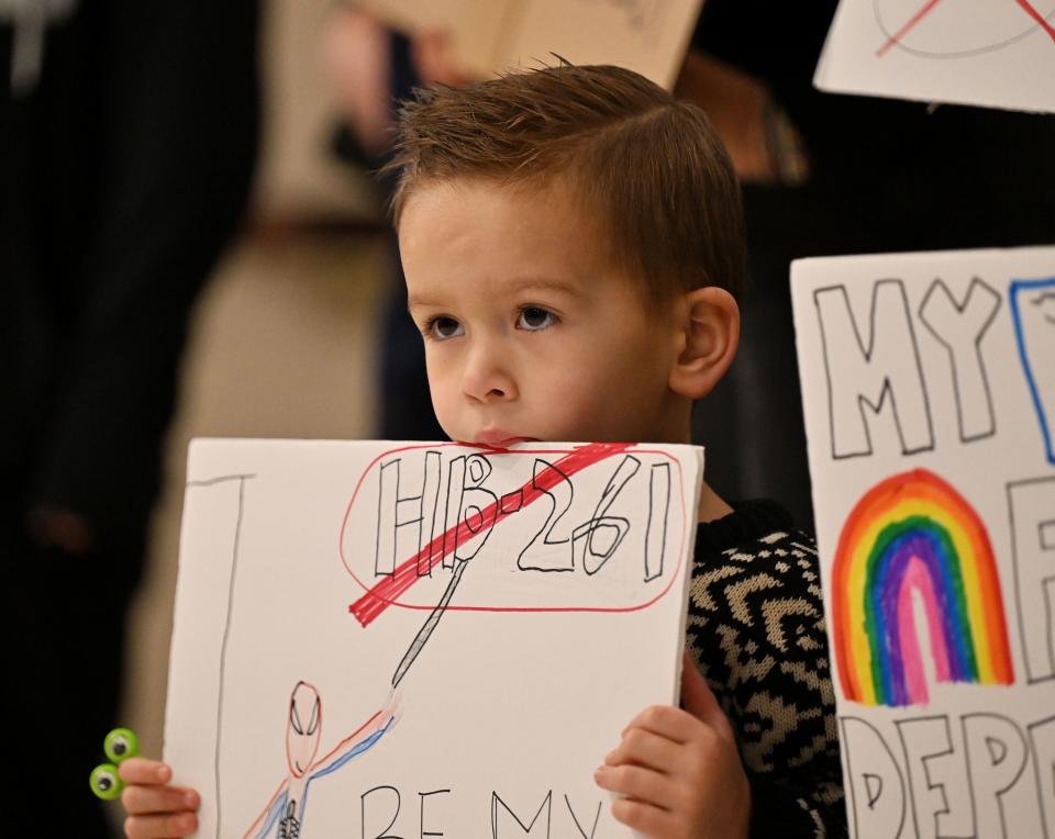 Tucker (no last name given) holds a sign as he joins his sisters and mother at a small protest outside the committee room as Senate members of the Education Standing Committee hear comments on HB261 at the Capitol in Salt Lake City on Monday, Jan. 22, 2024. The bill received a favorable recommendation. | Scott G Winterton, Deseret News