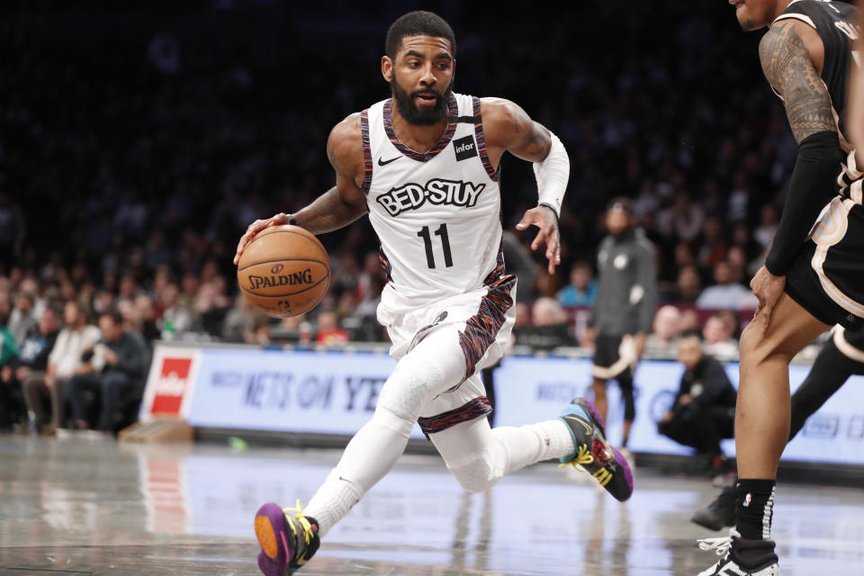 Brooklyn Nets guard Kyrie Irving (11) drives around Atlanta Hawks defense during the second half of an NBA basketball game, Sunday, Jan. 12, 2020, in New York. The Nets defeated the Hawks 108-86. (AP Photo/Kathy Willens)