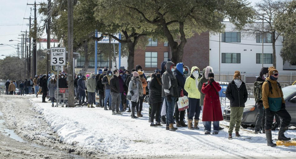 People wait in a long line to buy groceries during the extreme cold snap. Source: AP