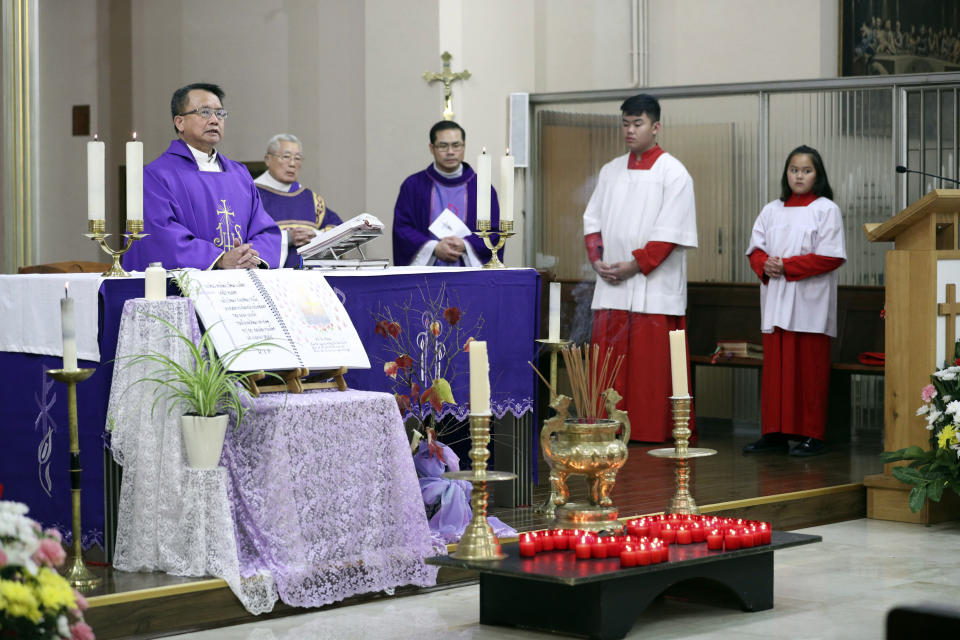 The priest of the Vietnamese Catholic Cathedral in east London, Father Simon Thang Duc Nguyen, speaks at The Holy Name and Our Lady of the Sacred Heart Church, London's Vietnamese church, in east London. Saturday Nov. 2, 2019, during a service and vigil to honor the 39 victims who died in a refrigerated truck container found on Oct. 23. The community is mourning the unidentified victims, who were trying to enter Britain in hopes of finding opportunity. (Yui Mok/PA via AP)