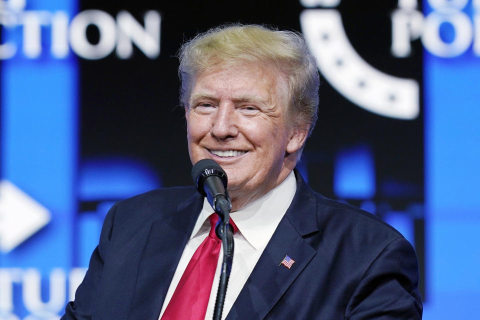 FILE - Former President Donald Trump smiles as he pauses while speaking to supporters at a Turning Point Action gathering in Phoenix, July 24, 2021. A criminal case brought by special counsel John Durham, the prosecutor appointed to investigate potential government wrongdoing in the early days of the Trump-Russia probe, heads to trial in Washington's federal court on May 16. The case centers on a single false statement that Michael Sussmann, a cybersecurity lawyer who represented the Hillary Clinton presidential campaign in 2016, is alleged to have made to the FBI during a meeting that year. (AP Photo/Ross D. Franklin, File)