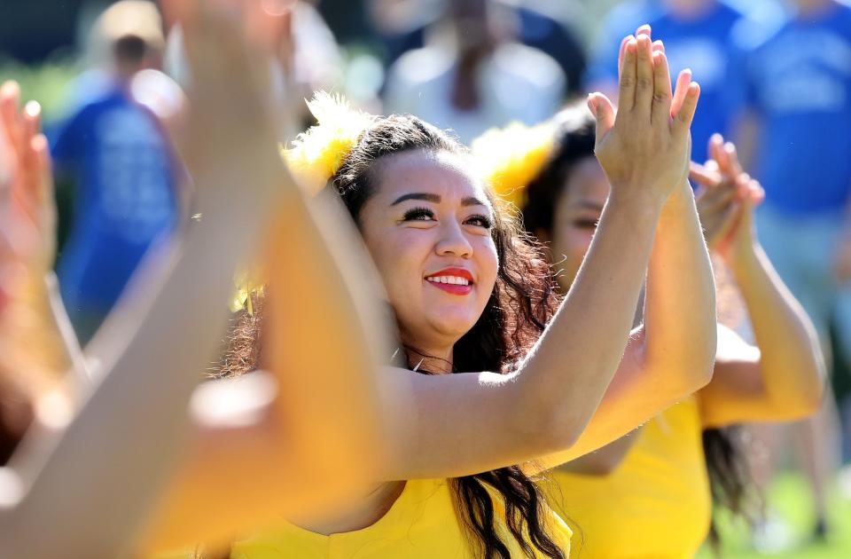 Fire Knife Dancer Mcailee Taliulu looks into the sky during a dance as her group performs as BYU holds a party to celebrate their move into the Big 12 Conference with music, games and sports exhibits in Provo on Saturday, July 1, 2023. | Scott G Winterton, Deseret News