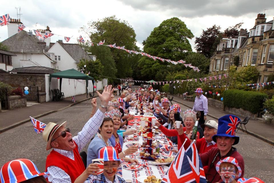 Residents of Murrayfield Drive in Edinburgh sit down to a Jubilee street party in 2012 (Andrew Milligan / PA)