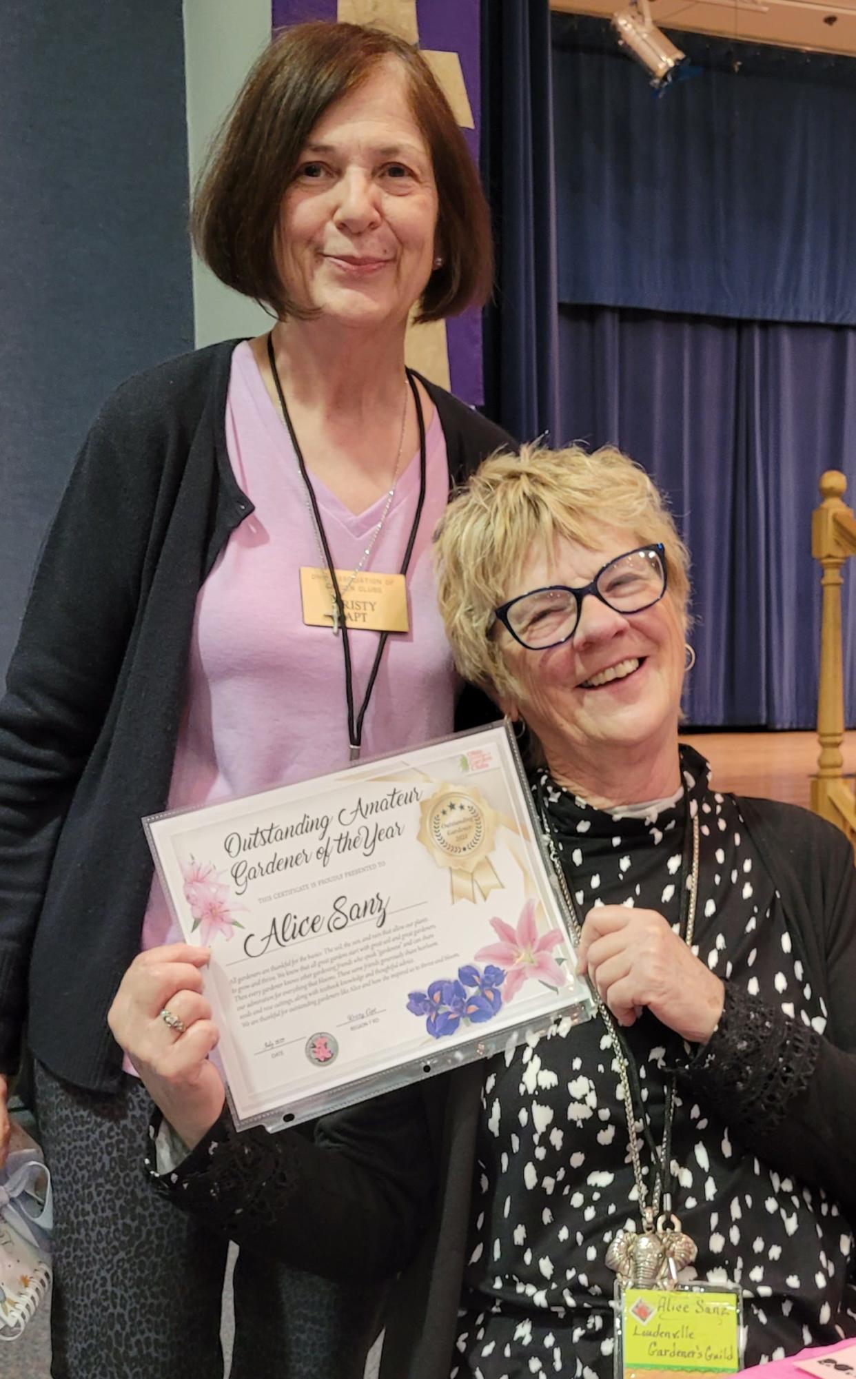 Looking happy as well as a little surprised is Alice Sanz after being presented Regional Gardener of the Year honors by Kristy Apt, region 7 Director, at the regional garden club meeting in April in Sunbury.