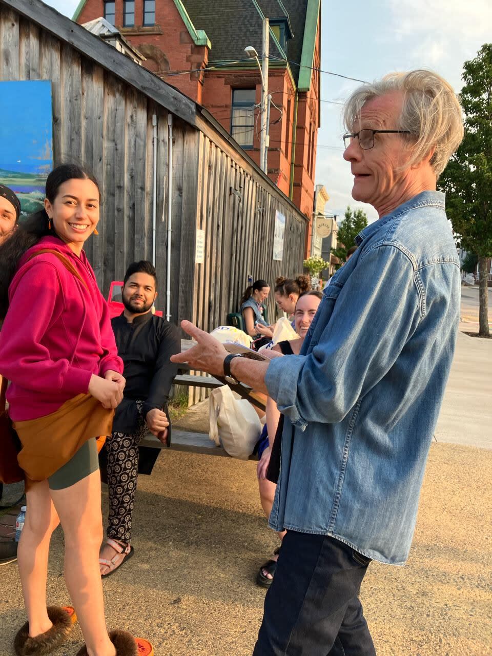 Randy Glynn, the artistic director of FODAR, talks to some dancers, including Katie Couchie and Tanveer Alam, during the 2023 festival. 