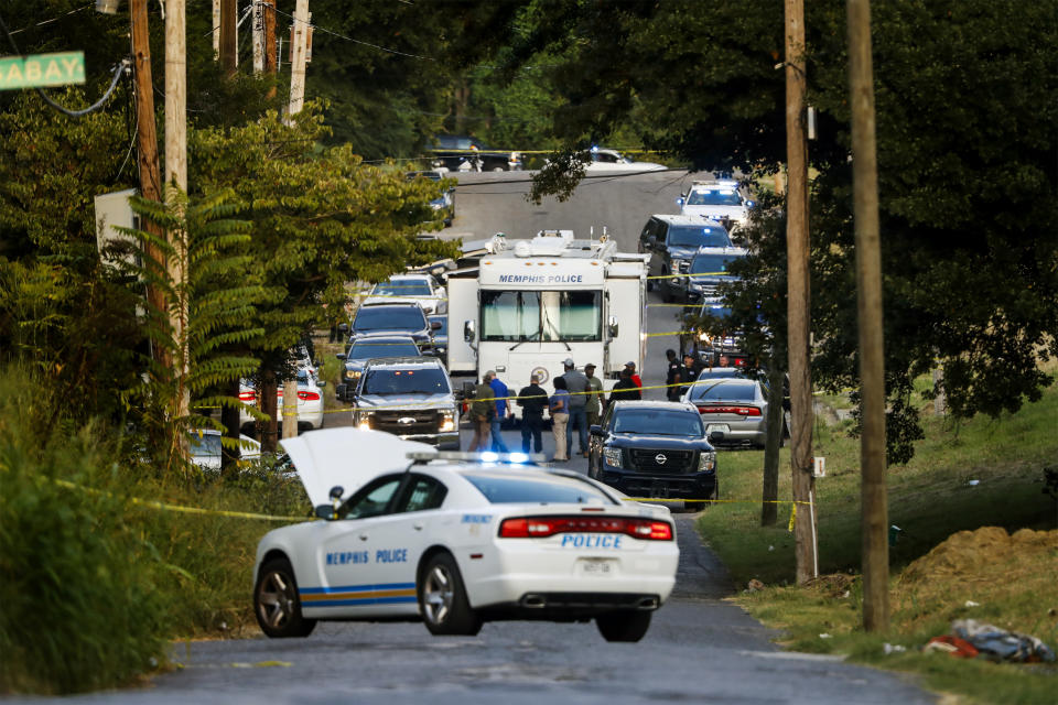 Memphis police officers search an area where a body had been found Monday. Police have not confirmed the identity of the body or the cause of death. (Mark Weber / AP)