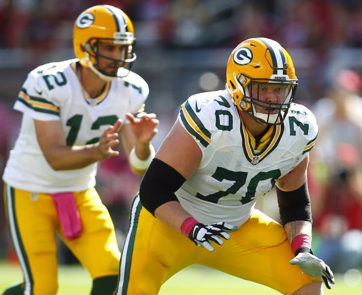 T.J. Lang (70) blocks for Aaron Rodgers. (AP)