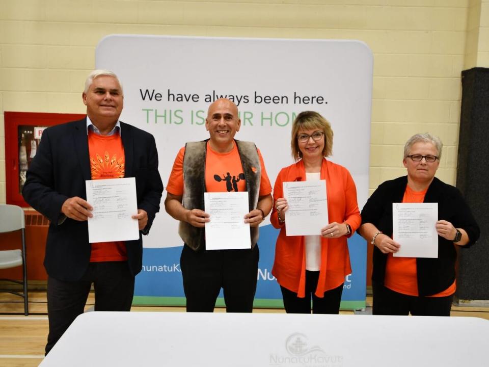 On Friday, from left, Scott Reid, parliamentary secretary to the minister of education, Todd Russell, NunatuKavut community council president, Lisa Dempster, Indigenous affairs minister, and Tina White, the English school district's assistant director of schools for Labrador, signed the memorandum.  (Submitted by Waylon Williams - image credit)