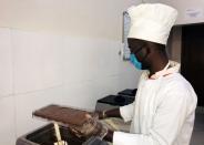 Chocolate maker Mussa Ahmad Lubenga prepares chocolate at the Lowa Chocolate Factory in Goma