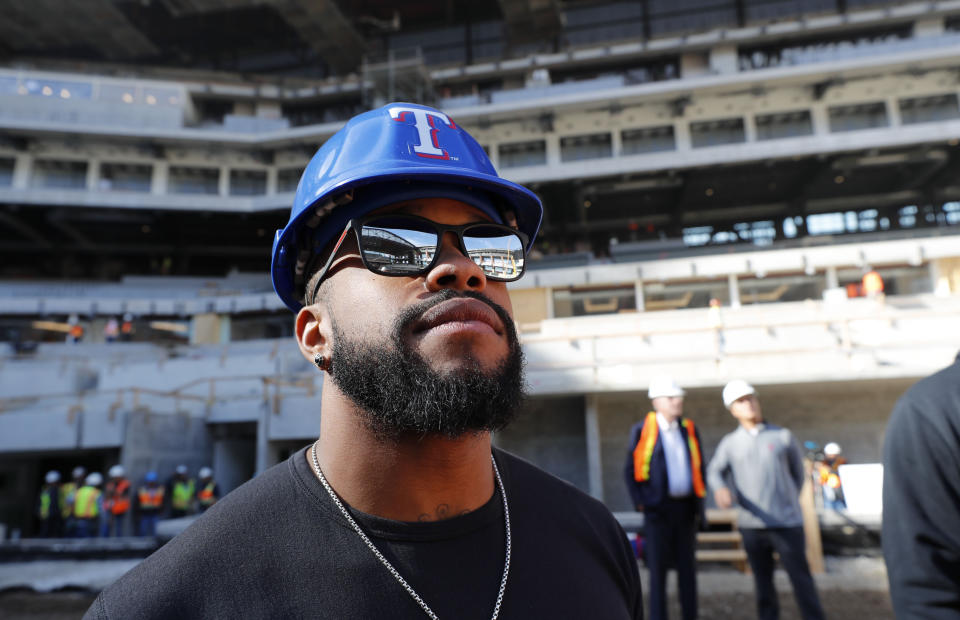 Texas Rangers outfielder Delino DeShields takes a look at the under construction baseball field at the new Rangers stadium in Arlington, Texas, Wednesday, Dec. 4, 2019. (AP Photo/LM Otero)