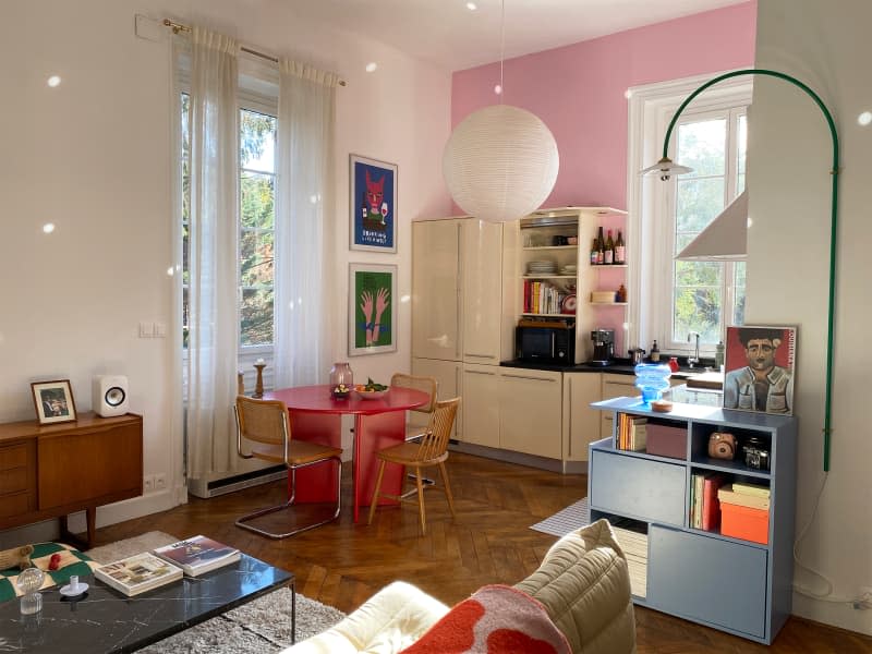 Large paper pendant near pink painted kitchen in eclectic apartment.