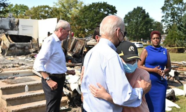 Joe Biden embraces a person as he tours a neighborhood affected by Hurricane Ida in Manville, New Jersey, in September.