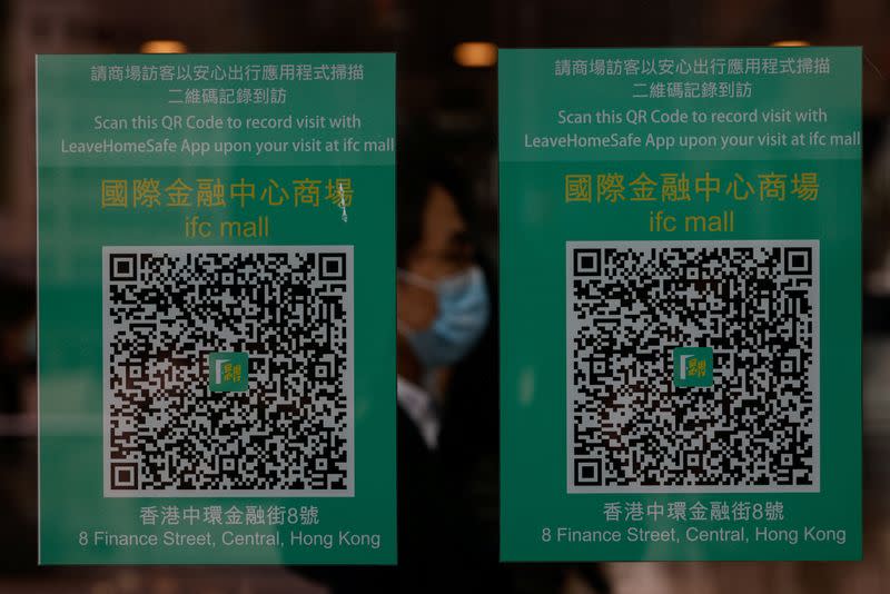 QR codes for the "LeaveHomeSafe" COVID-19 contact-tracing app are seen inside a shopping mall in Hong Kong