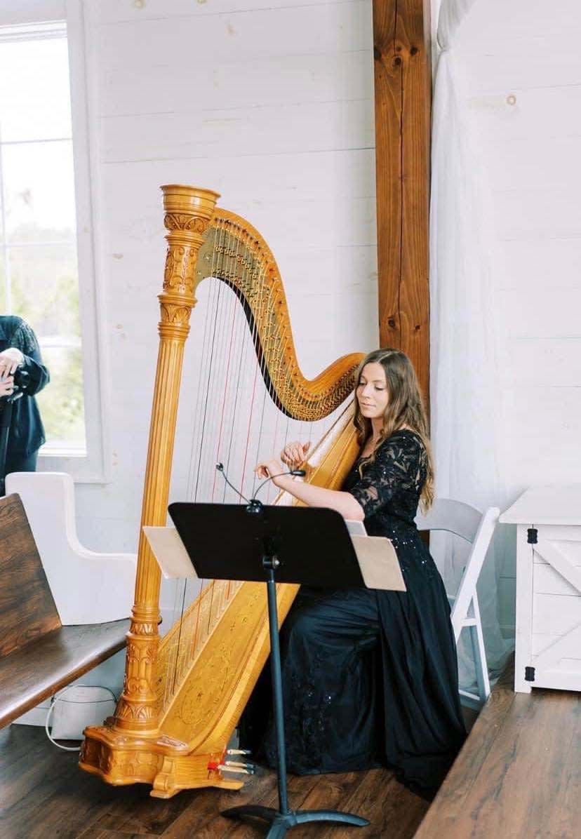 Joanna Seiber plays her harp at a wedding at Howe Farms in Chattanooga, Tennessee, fall 2023.