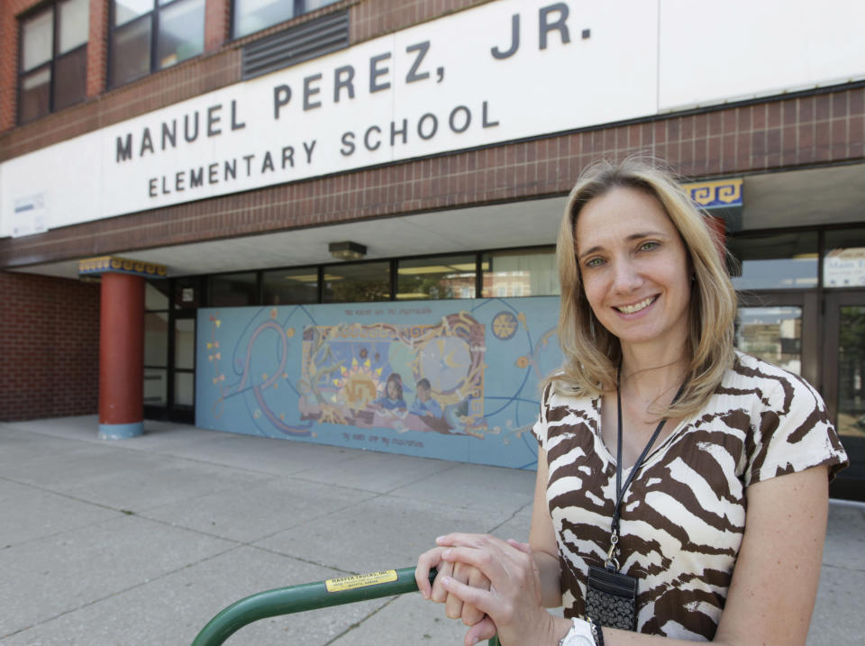 In this Friday, Aug. 31, 2012 photo, Vicky Kleros, principal of the Manuel Perez Jr. Elementary School in Chicago's predominantly Hispanic Pilsen neighborhood, just southwest of downtown, poses outside her school. Chicago Teachers Union President Karen Lewis said more than 26,000 teachers and support staff in the nation's third-largest school district don't want to strike, but are prepared to do so for the first time in 25 years. If there is a strike, Kleros said the school would be open from 8:30 a.m. to 12:30 p.m. every school day so that children still could get breakfast and lunch and participate in activities that would keep them off the streets. Later in the afternoon, the local library and park district buildings will be open - all part of a $25 million school district strike contingency plan. (AP Photo/M. Spencer Green)