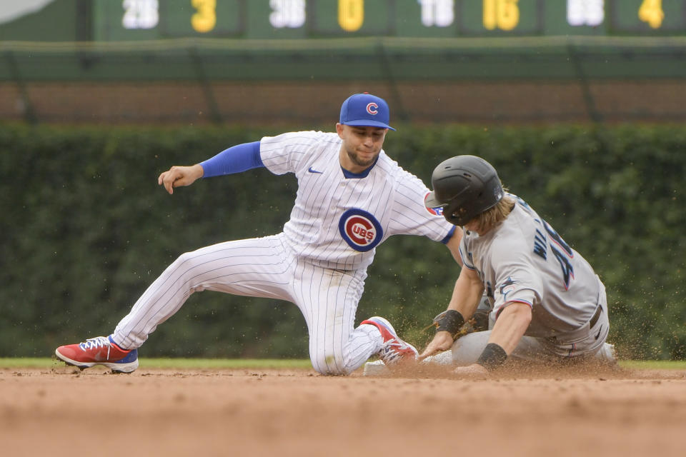 Chicago Cubs second baseman Nick Madrigal, left, tags out Miami Marlins' Luke Williams during the fifth inning of a baseball game, Sunday, Aug. 7, 2022, at Wrigley Field in Chicago. (AP Photo/Mark Black)