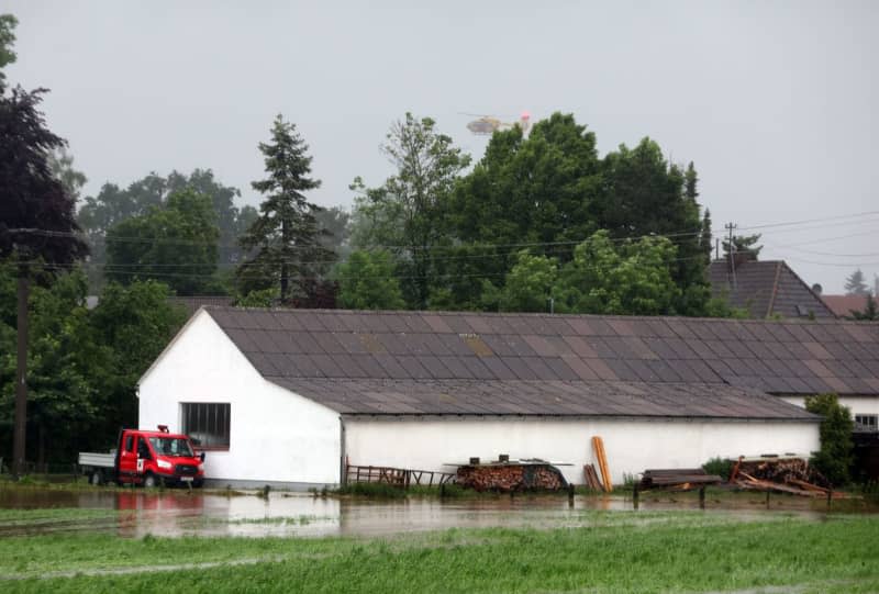 A helicopter circles over the village during the flood situation. Karl-Josef Hildenbrand/dpa