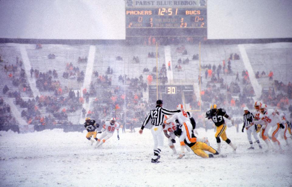 1985 SEASON: Defensive end Robert Brown (93) and fellow defensive linemen pursue Tampa Bay quarterback Steve Young (8) during the game at Lambeau Field on Dec. 1, 1985. There were plenty of empty seats. Only 19,856 could get to the stadium when more than a foot of wet, heavy snow, 30-mph winds and 30-degree temperatures provided the backdrop to the Packers' 21-0 victory over the Buccaneers in what has come to be known as the Snow Bowl.