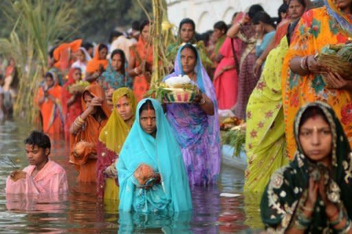 Indian Hindu devotees pay homage during Chhat Puja while standing in the sarover of the Durgiana temple in Amritsar. The festival of Chhath is celebrated across India and the number of devotees was likely to swell at dawn on Tuesday when many more worshippers are expected to throng rivers to offer prayers to the rising sun