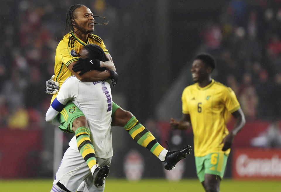 Jamaica's Bobby De Cordova-Reid, top left, celebrates with goalkeeper Andre Blake after the team's win over Canada in the second leg of a CONCACAF Nations League soccer quarterfinal in Toronto on Tuesday, Nov. 21, 2023. (Chris Young/The Canadian Press via AP)