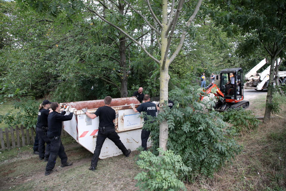 Police officers dig and search a garden plot in Hannover, northern Germany. Police is working on the site in relation to the investigation of the Madeleine 'Maddie' McCann case. 