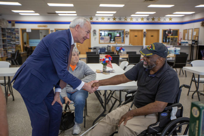 File: Asa Hutchinson, governor of Arkansas, left, meets a Desert Storm veteran during a campaign event at the Quad City Veterans Outreach Center in Davenport, Iowa, US, on Thursday, May 18, 2023.&nbsp; / Credit: Rachel Mummey/Bloomberg via Getty Images