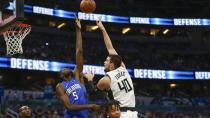 Los Angeles Clippers center Ivica Zubac (40) shoots over Orlando Magic center Mo Bamba (5) during the second quarter of an NBA basketball game in Orlando, Fla., Sunday, Jan. 26, 2020. (AP Photo/Reinhold Matay)