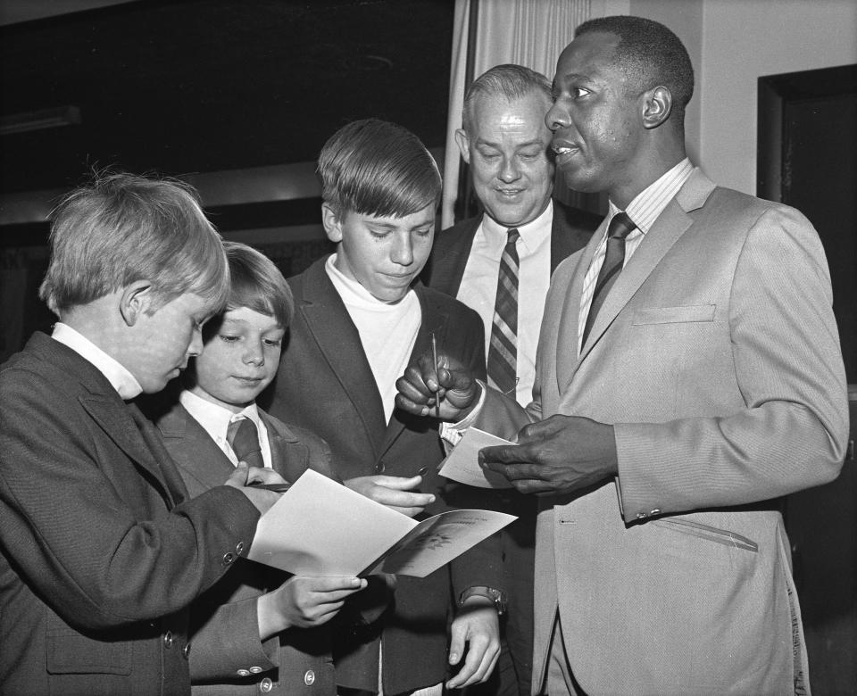 Henry "Hank" Aaron signs autographs at a Jacksonville Suns banquet to honor him at the George Washington Hotel in 1970.