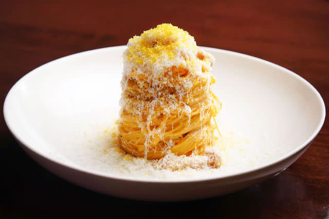 <p>Hakan Burcuoglu</p> Italian and Japanese cultures combine in Kissa Tanto's tajarin, buttery pasta tossed with roasted shimeji and shiitake mushrooms and showered in Parmesan and miso-cured egg yolk