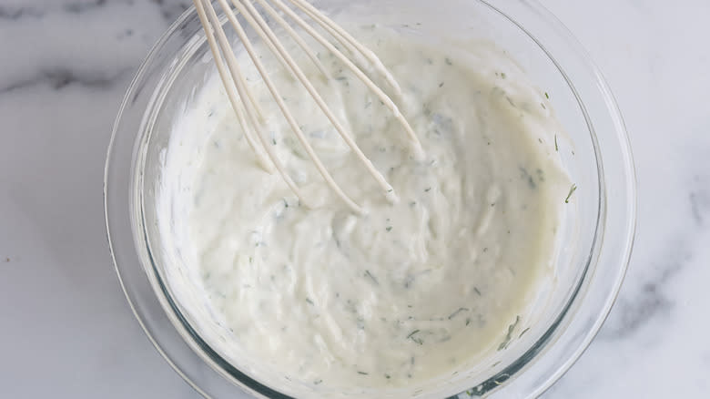 tzatziki in a bowl with a whisk