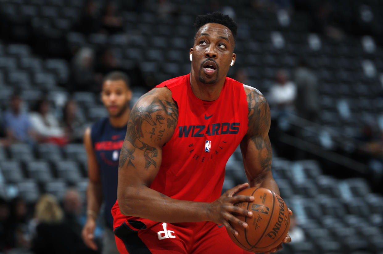 Injured Washington Wizards center Dwight Howard practices before the Wizards face the Denver Nuggets in the first half of an NBA basketball game Sunday, March 31, 2019, in Denver. (AP Photo/David Zalubowski)