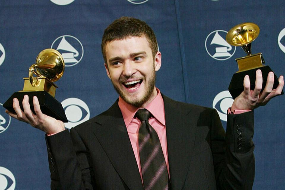 Timberlake in his heyday in 2004, posing with two Grammy awards (Getty)