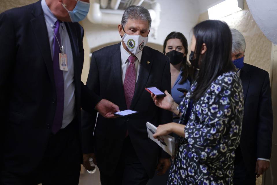 Sen. Joe Manchin, D-W.Va., talks to reporters in a hallway at the U.S. Capitol on Sept. 28, 2021 in Washington, D.C.