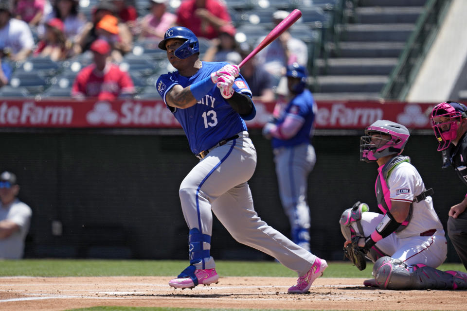 Kansas City Royals' Salvador Perez, left, hits a single as Los Angeles Angels catcher Logan O'Hoppe watches during the first inning of a baseball game Sunday, May 12, 2024, in Anaheim, Calif. (AP Photo/Ashley Landis)