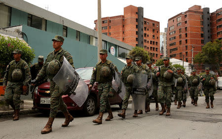 Soldiers patrol a street near the Electoral National Council (CNE) headquarters prior to Sunday presidential election in Quito, Ecuador, April 1, 2017. REUTERS/Mariana Bazo