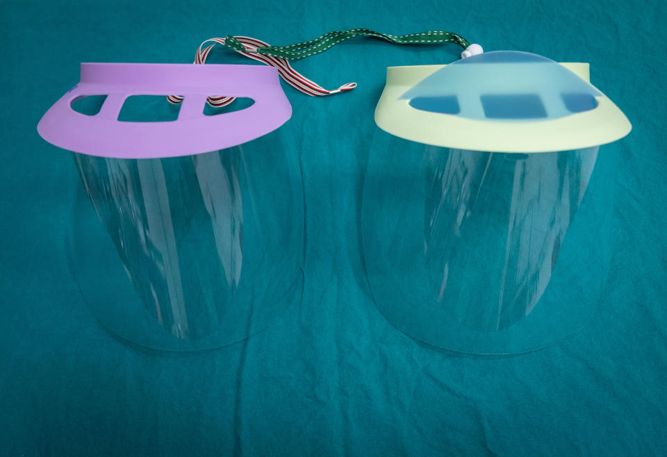 Twin plastic protective face shield preparing for use in operating room in hospital. (Getty Images stock)