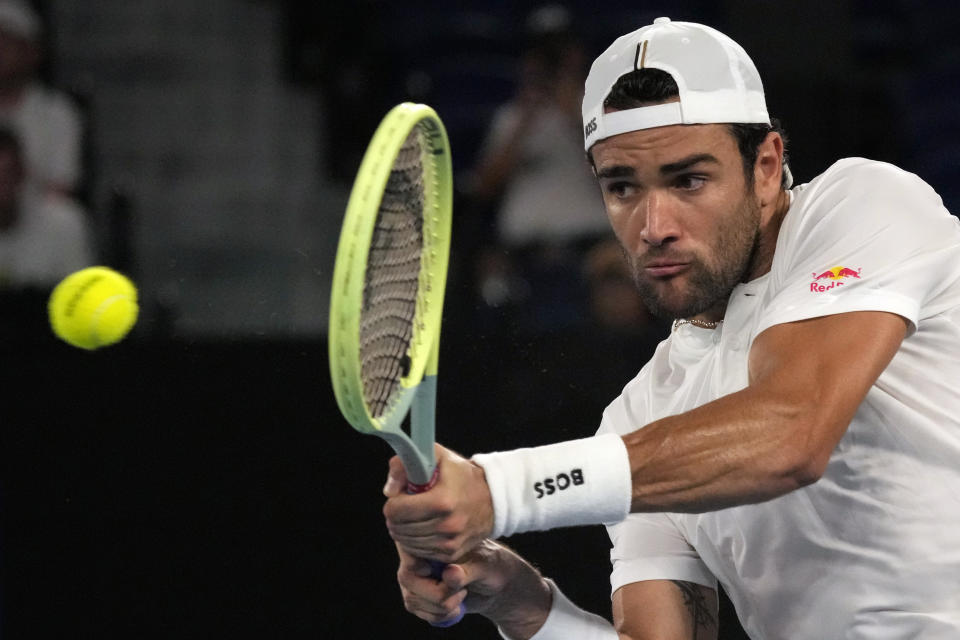 Matteo Berrettini of Italy plays a backhand return to Andy Murray of Britain during their first round match at the Australian Open tennis championship in Melbourne, Australia, Tuesday, Jan. 17, 2023. (AP Photo/Aaron Favila)