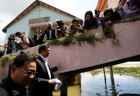 Kem Sokha (2nd, L), leader of the Cambodia National Rescue Party (CNRP), leaves after he registers for next year's local elections, in Phnom Penh, Cambodia October 5, 2016. REUTERS/Samrang Pring